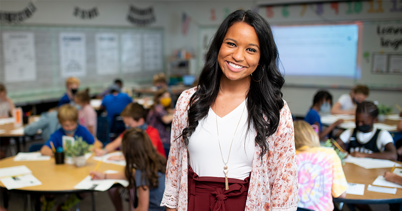 smiling teacher in classroom