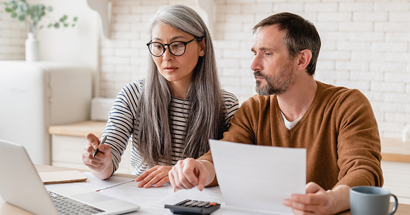 man and woman at table reviewing finances