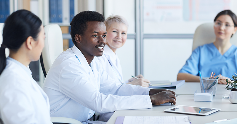 student nurses around table with professor