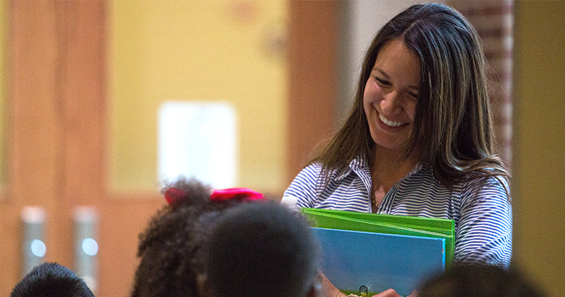 teacher smiling at students