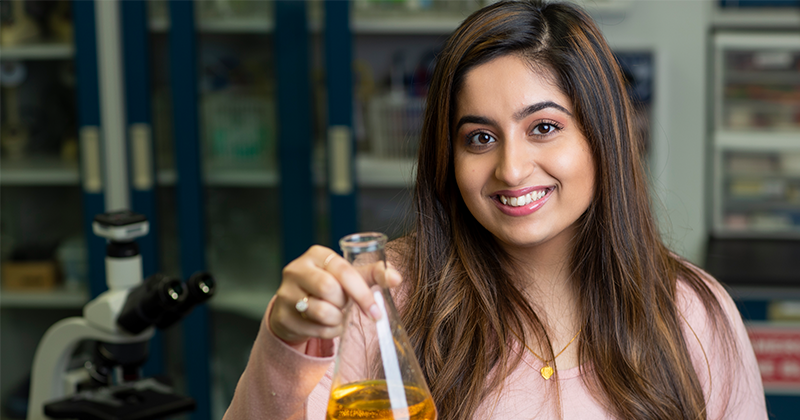 woman holding a beaker in a lab