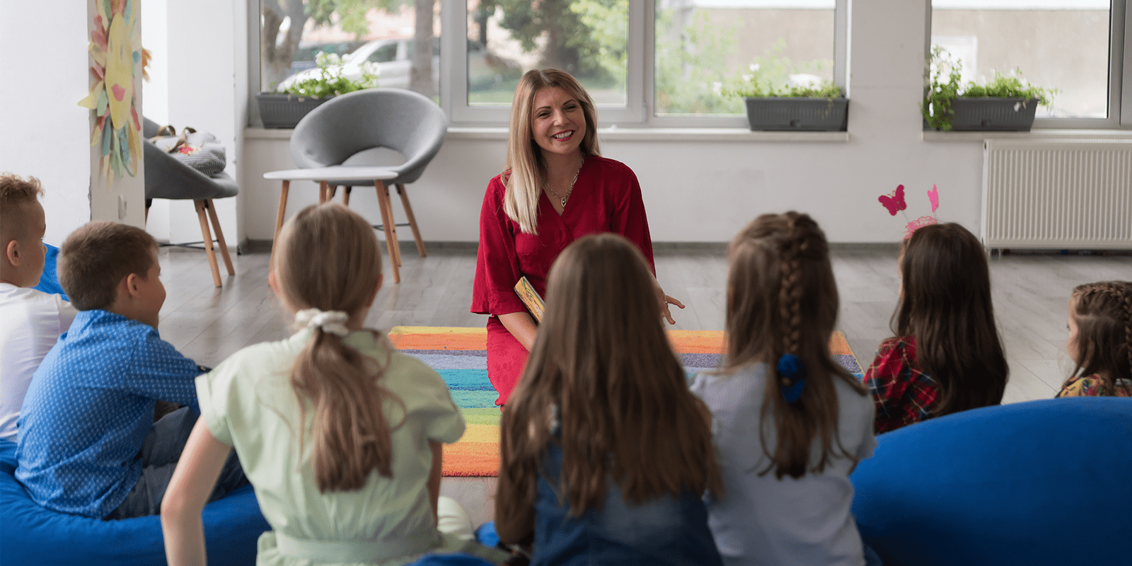 woman in red dress at front of classroom teaching special education